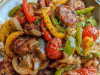 Sausage, Onion, Bell Peppers & Tomatoes Over Rice