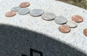The Meaning Behind the Tradition of Coins on Gravestones