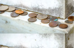 The Meaning Behind the Tradition of Coins on Gravestones: A Silent Language of Remembrance